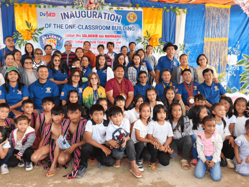 Bashoy Elementary School students, teachers, and DepEd officials celebrate the newly blessed classroom, which now features sustainable solar power and internet connectivity | Contributed photo (Click the photo to view full image)