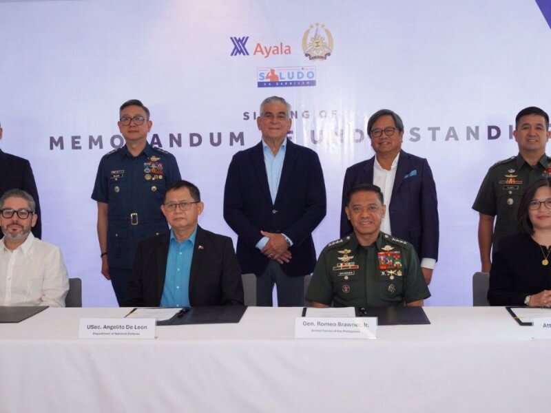 Ayala Corp. chief human resources officer Francisco Romero Milán, Defense Undersecretary Angelito De Leon, AFP Chief of Staff General Romeo S. Brawner Jr., and Ayala Corp.  chief legal officer Atty. Franchette M. Acosta at the signing of the MOU on Saludo sa Serbisyo on 15 July 2025 in Makati City. Behind them standing as witnesses (L-R) are Ayala Corp. head of security management Gen. Emmanuel T. Bautista (Ret); AFP Deputy Chief of Staff Lt. Gen. Rommel P. Roldan; Ayala Corp.  chair Jaime Augusto Zobel de Ayala; Ayala Corp. president and CEO Cezar P. Consing, and AFP Deputy Chief of Staff for Personnel, J1 Brig. Gen. Ramon P. Flores./ Contributed photo (Click the photo to view full image)