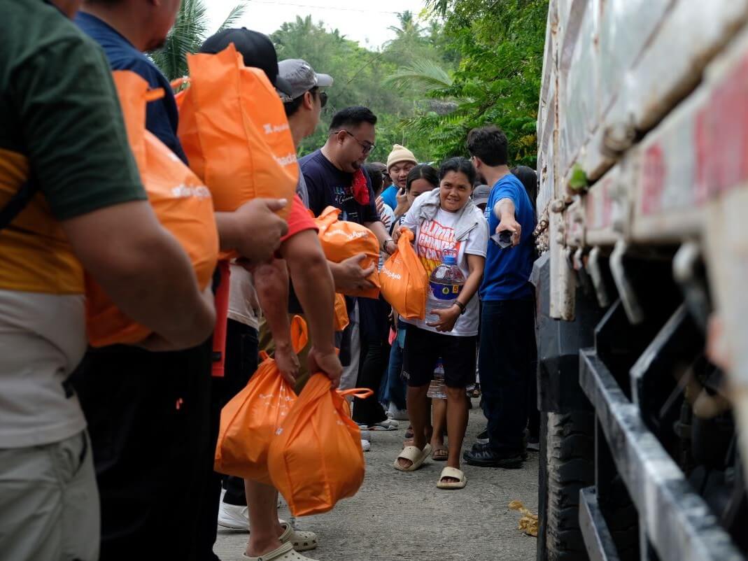 Ayala Group volunteers distribute food packs to residents in Brgy. San Miguel, San Remigio , Cebu. | Contributed photo