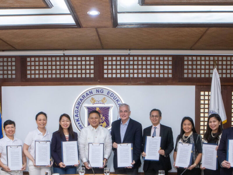 Education Secretary Sonny Angara and Ayala Foundation chair Fernando Zobel de Ayala (6th and 7th from left) show the signed MOU. With them are (from left) University of Nueva Caceres president Fay Lea Lauraya; Edizon Fermin,  vice president for academic affairs, National Teachers College; Myrish Antonio, COO, Khan Academy Philippines; Geraldine Acuña-Sunshine, CEO, Khan Academy Philippines; Education Undersecretary Fatima Panontongan; Alfredo Ayala, president, iPeople; Maria Margarita Trinidad, head of strategy & impact, Ayala Foundation; Janice Racpan, Globe Telecom; Emil Francis De Quiros, Ayala Foundation, and Felipe Estrella, CFO, Ayala Foundation.  (Click to view the full image)/ Contributed photo