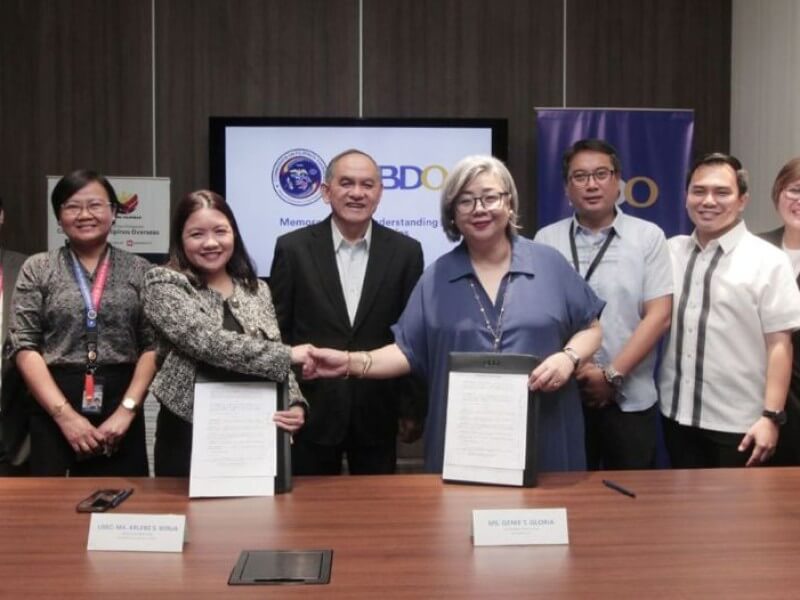 Commission on Filipinos Overseas (CFO) Undersecretary Atty. Arlene S. Borja (4th from left) shakes hands with BDO Unibank Senior Vice President and Head of Remittance Genie T. Gloria (6th from left) to formalize the partnership. Joining them are former Labor Secretary Marianito “Nitoy” Roque (5th) along with other CFO and BDO officers./ Photo from BDO  (Click ​to view full image)
