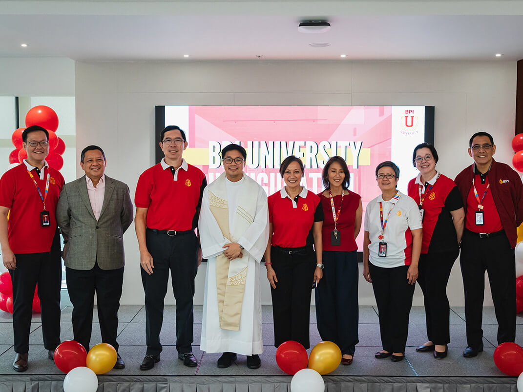 BPI University launch: From L-R: Alex Seminiano, chief technology officer; John-C Syquia, institutional banking head; TG Limcaoco, president and CEO; Reverend Father Paolo Asprer; Gina Eala, chief human resources officer; Jojo Ocampo, mass retail products head; Tin Asis, chief risk officer; Cathy Santamaria, chief customer and marketing officer; and Gene Mercado, head of enterprise operations./Contributed photo