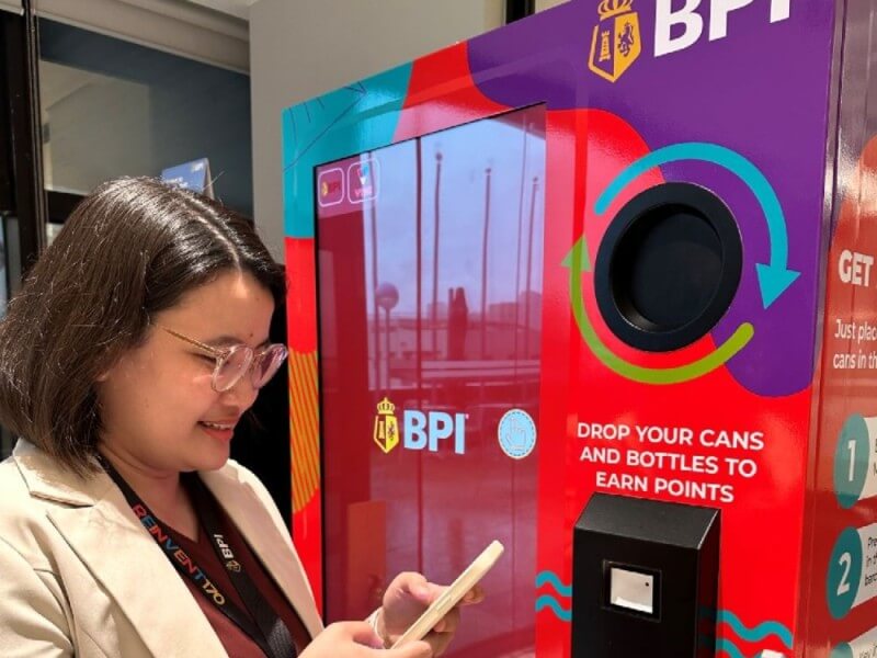 BPI employees use the Reverse Vending Machine (RVM) to recycle clean PET bottles and aluminum cans. By doing so, they earn BPI Rewards Points redeemable via the VYBE by BPI app./ Photo from BPI