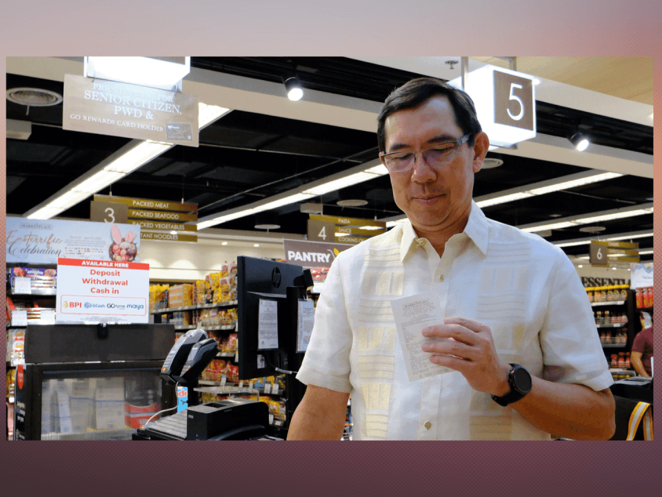 BPI President and CEO TG Limcaoco holds the first receipt from a deposit via barcode transaction at The Marketplace. | Contributed photo