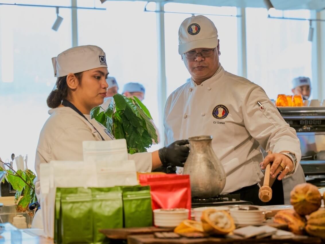 Chef OJ Gomez, a CCA Manila alumnus and seed-to-bar chocolatier, demonstrates traditional Philippine cacao preparation during the Philippine Heritage Kitchen launch, with CCA Manila students assisting in celebrating local cacao heritage and Filipino culinary traditions. | Contributed photo