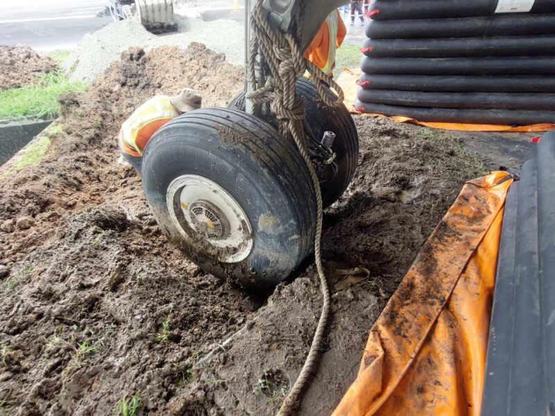 A Cebu Pacific A321neo plane swerved into the grass and became stuck in the mud while being towed at the Ninoy Aquino International Airport Terminal 3. (Photo Courtesy of the Manila International Airport Authority). 