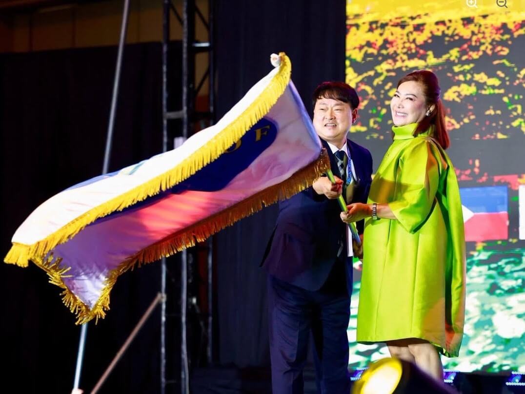 Lee Dong-hee, permanent secretary-general of the East Asia Inter-Regional Tourism Federation (EATOF), holds the official EATOF flag with Cebu Gov. Pamela Baricuatro during the opening ceremony of the 19th EATOF General Assembly at Mactan Expo in Mactan Newtown, Lapu-Lapu City.| Photo from Cebu province&nbsp;