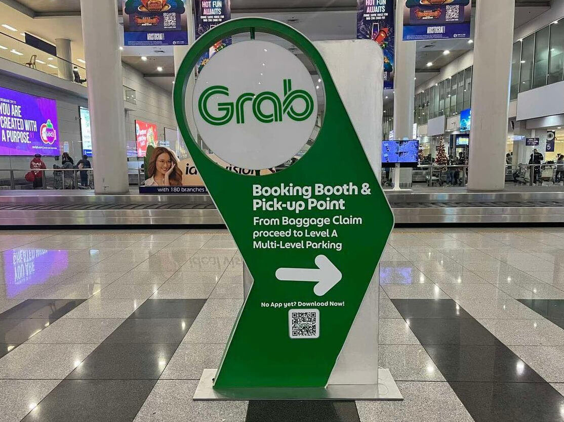 Grab signage at the baggage claim area of NAIA Terminal 3 pointing passengers to the pickup point of the country's largest TNVS operator./Contributed Photo