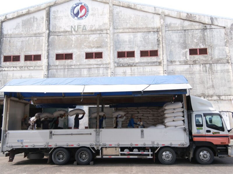 Workers load sacks of rice into a truck at an NFA warehouse./ Photo from DA
