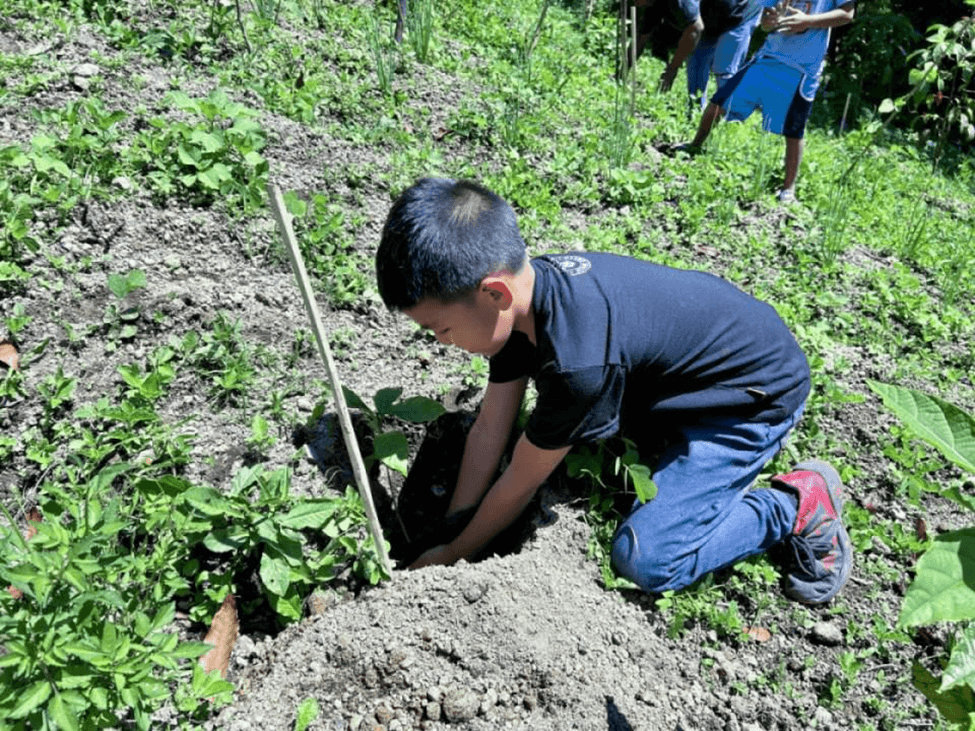 Roots in the ground, eyes on the future: This elementary student, one of 77 participating students from Albagan Elementary School in Tampakan, South Cotabato, is not just planting a tree for Arbor Day, but for the future they want to live in. | Contributed photo