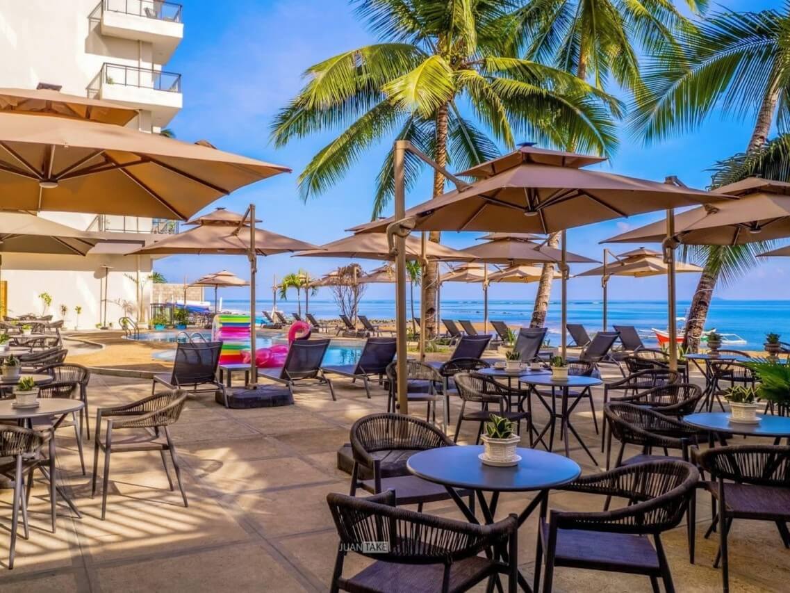 The open-air dining area at Angel Garden Resort offers a laid-back poolside setting framed by palms and sea views. | ​Contributed photo