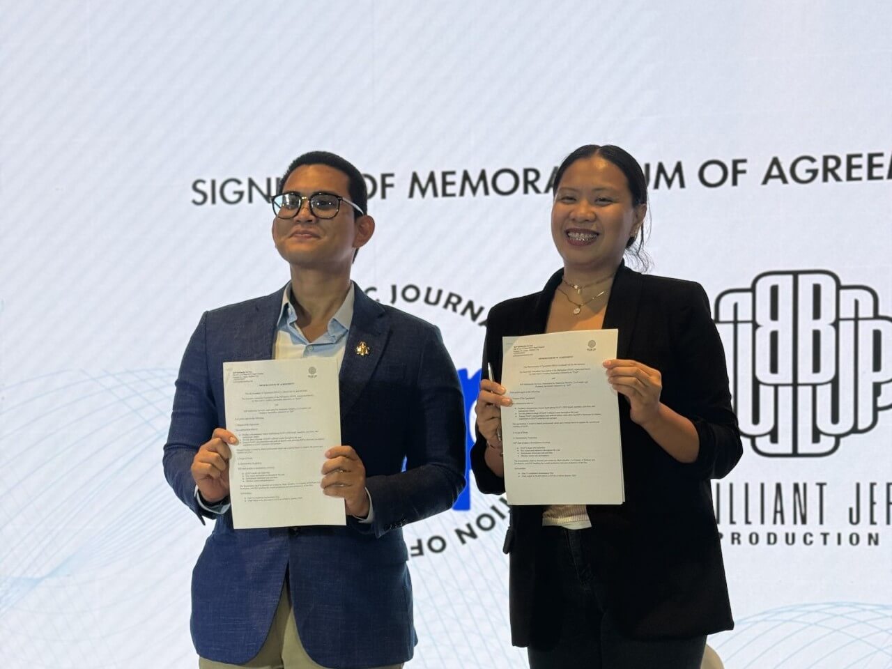 John Ted O. Cordero, president of EJAP, and Madeleine &ldquo;Mads&rdquo; Miraflor, co-founder and producer at BJP, during the signing for the documentary project. The film will document the more than four-decade-old business media organization from the inside./Contributed photo&nbsp;