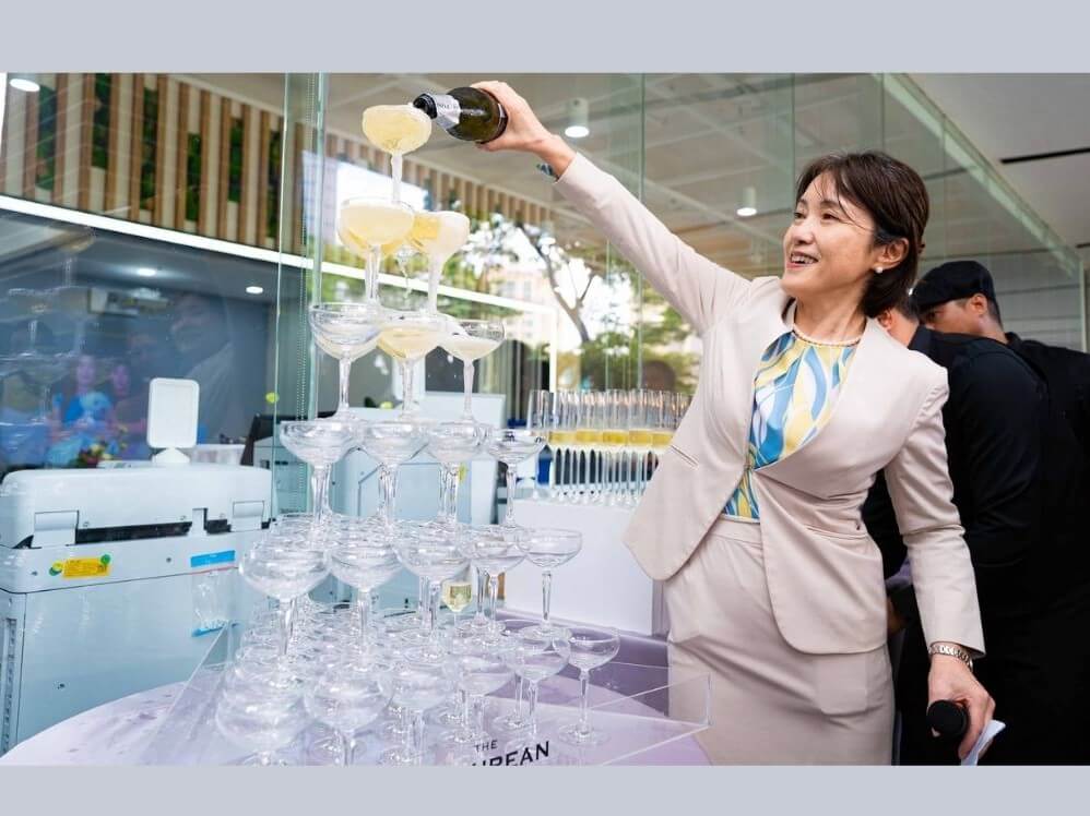 Epson Philippines president and director Masako Kusama pours champagne on the glass tower before the ceremonial toast at the Epson Cebu Office Launch. &nbsp;| Contributed photo