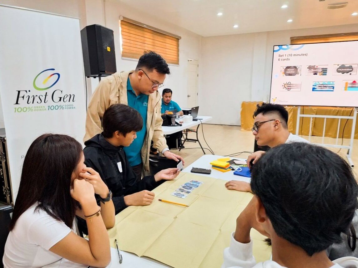 A First Gen employee (third from left) helps a team of students visualize and simplify their ideas about climate change and the environment during a conference, dubbed Youth for Climate and Energy Leadership Summit, which First Gen organized recently. First Gen, along with partner organizations, designed the summit as a tool to equip young participants with the knowledge and skills that would help them address climate- and energy-related issues in their communities./ Contributed photo