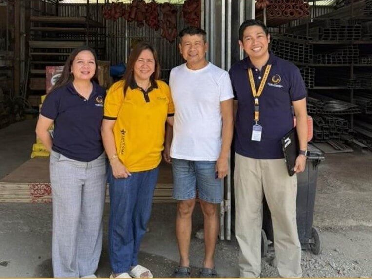 Richard Dea&ntilde;o (third from left), owner of a hardware and construction supplies business, poses with Global Dominion employees, reflecting a financing partnership that has supported his business expansion. | Contributed photo