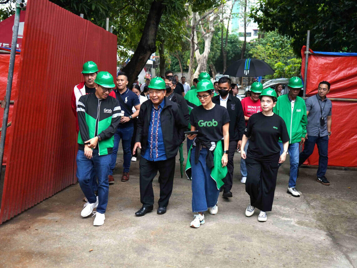 Transportation Secretary Bautista and leaders from Grab Philippines inspect the ongoing construction of the expanded Grab Asenso Center./Contributed photo