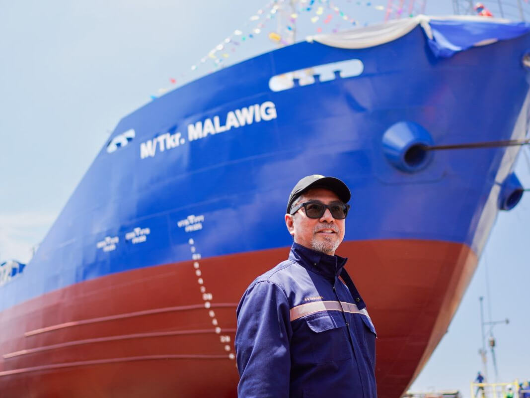 Herma Group founder, chair, and CEO Herminio S. Esguerra stands in front of M/Tkr Malawig/ &nbsp;Contributed photo