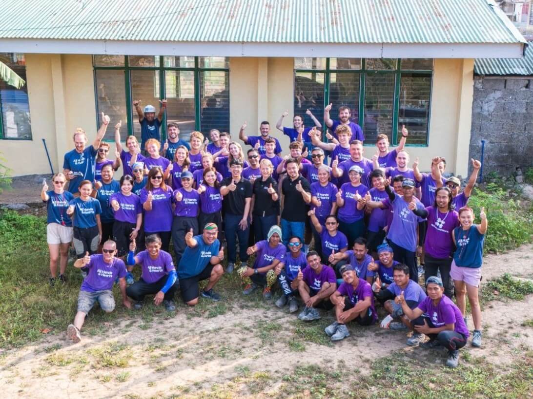 Home Credit Philippines employees join volunteers from All Hands & Hearts and Happy Hearts Czech during the rehabilitation of Salvacion Elementary School in Caramoran, Catanduanes. The initiative aims to restore safer learning spaces for students in a community frequently affected by severe typhoons. | Contributed photo