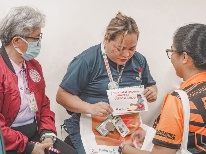 Dr. Norena R. Osano (left), former City Health officer of Taguig City, engages with health workers during a workplace-based cervical cancer screening activity. | Contributed photo