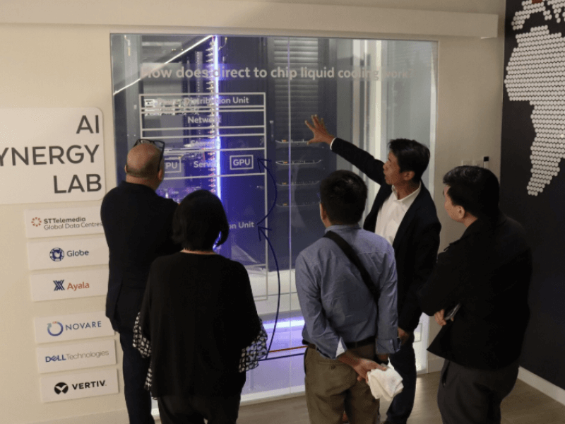 STT GDC Philippines CEO Carlo Malana demonstrates how direct-to-chip liquid cooling works inside the STT Makati's AI Synergy Lab, a showcase for next-generation data center technology.