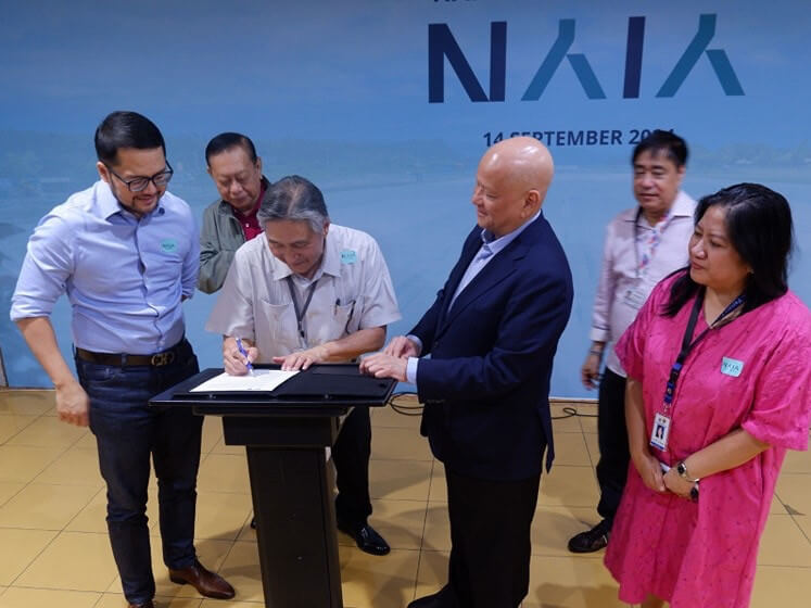 Signed, sealed, and delivered... at the stroke of midnight. Transportation Undersecretary Roberto Lim signs the turnover documents during the simple turnover ceremony at 12 a.m. Saturday./DOTr photo
