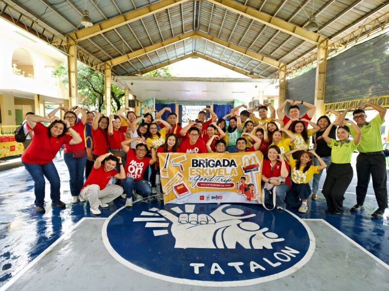 McDonald's Philippines employee volunteers gather during a Brigada Eskwela activity at Diosdado Macapagal Elementary School in Quezon City, where they helped repaint classrooms, clean school facilities and distribute school kits through the company's Good Trip volunteerism platform ahead of the opening of classes. | Contributed photo
