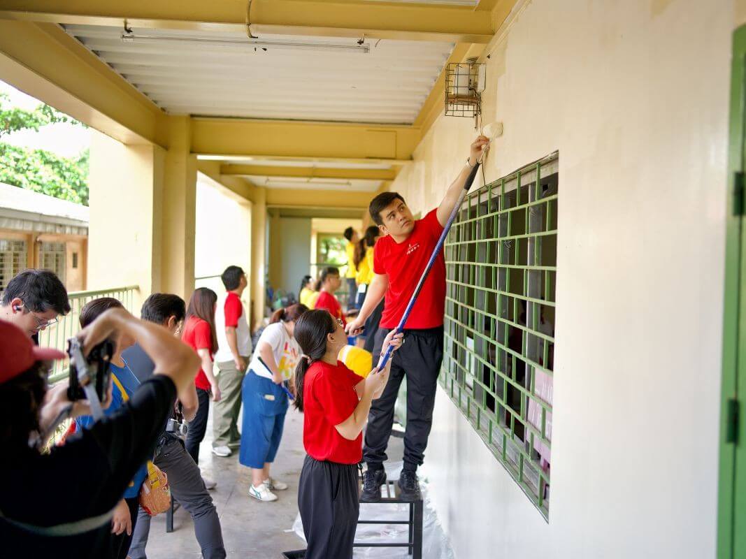 Volunteers from the McDonald's Restaurant Support Center repaint a classroom at Diosdado Macapagal Elementary School in Quezon City during a Good Trip volunteer activity supporting this year's Brigada Eskwela program. | Contributed photo