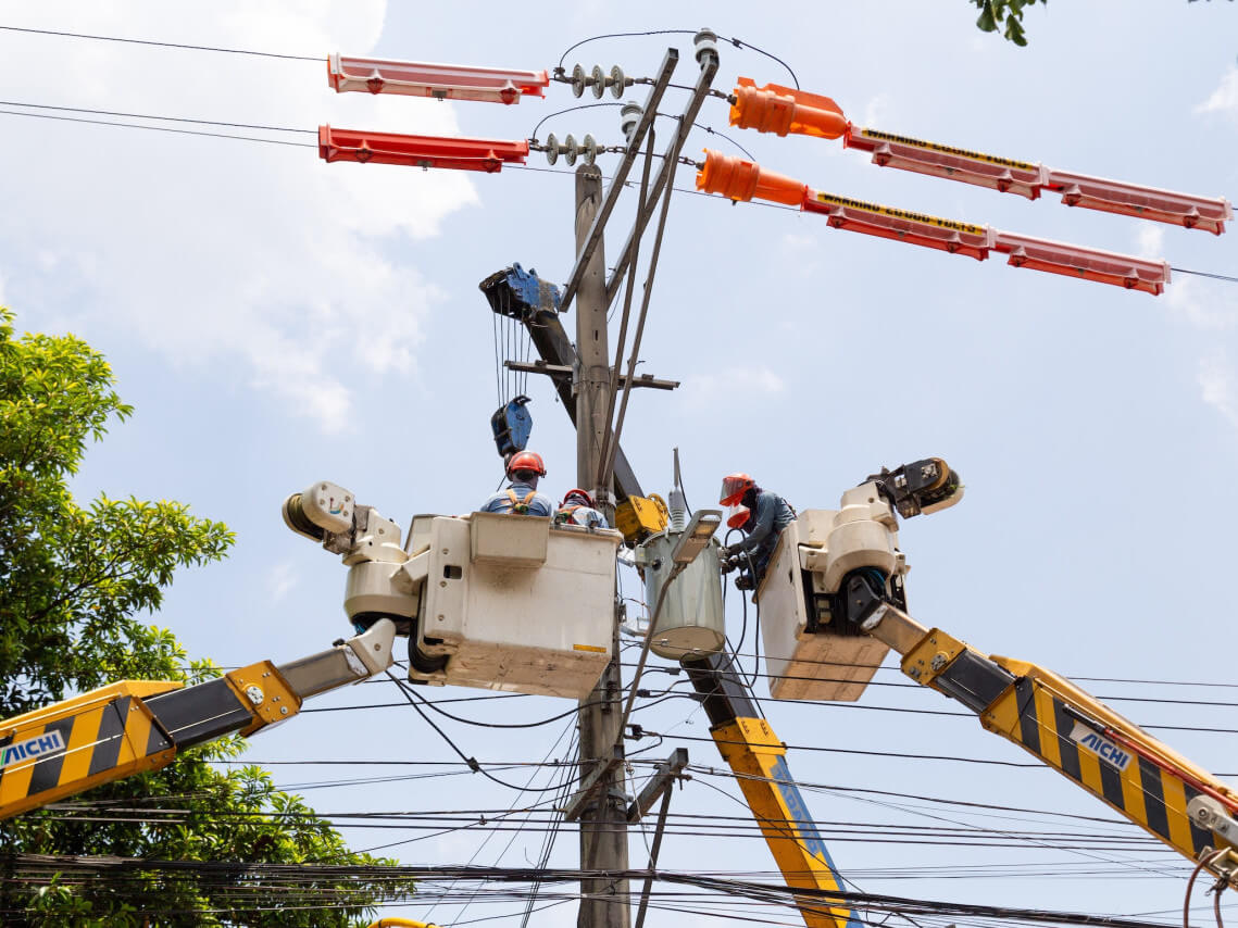 Meralco repair crews perform maintenance work on a electric pole ahead of the long weekend./Contributed Photo