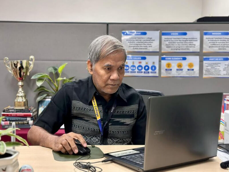 NTC Principal Fidel Soriano, who has been with the institution as a student, science teacher, and now administrator for almost 30 years, prepares for an upcoming class./ Contributed photo