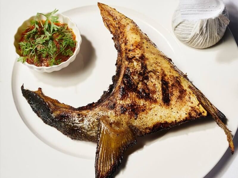 Aurora’s standout hamachi collar, grilled to a smoky finish and paired with lime and peanut sauce, captures the restaurant’s quiet precision and depth of flavor./Photo from Aurora's website 