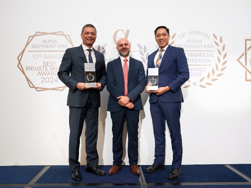 The photo shows Emilio Manuel Pascua, ICTSI senior vice president, chief financial officer, and chief risk officer (far right), and Arthur Tabuena, treasury director and head of investor relations (far left), receiving the awards on behalf of ICTSI on July 9, 2024, in Singapore.