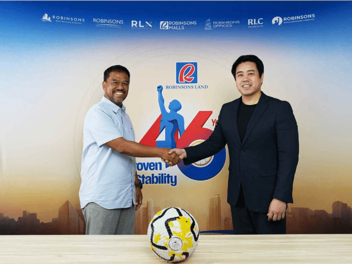 Representing a shared commitment to youth development through sports, LAOS FC vice president and head of youth programs Atty. Yayie Doque IV and Robinsons Sports and Leisure general manager Ramon Rivero mark the partnership that will help support the club's journey to Norway Cup2026. | Contributed photo