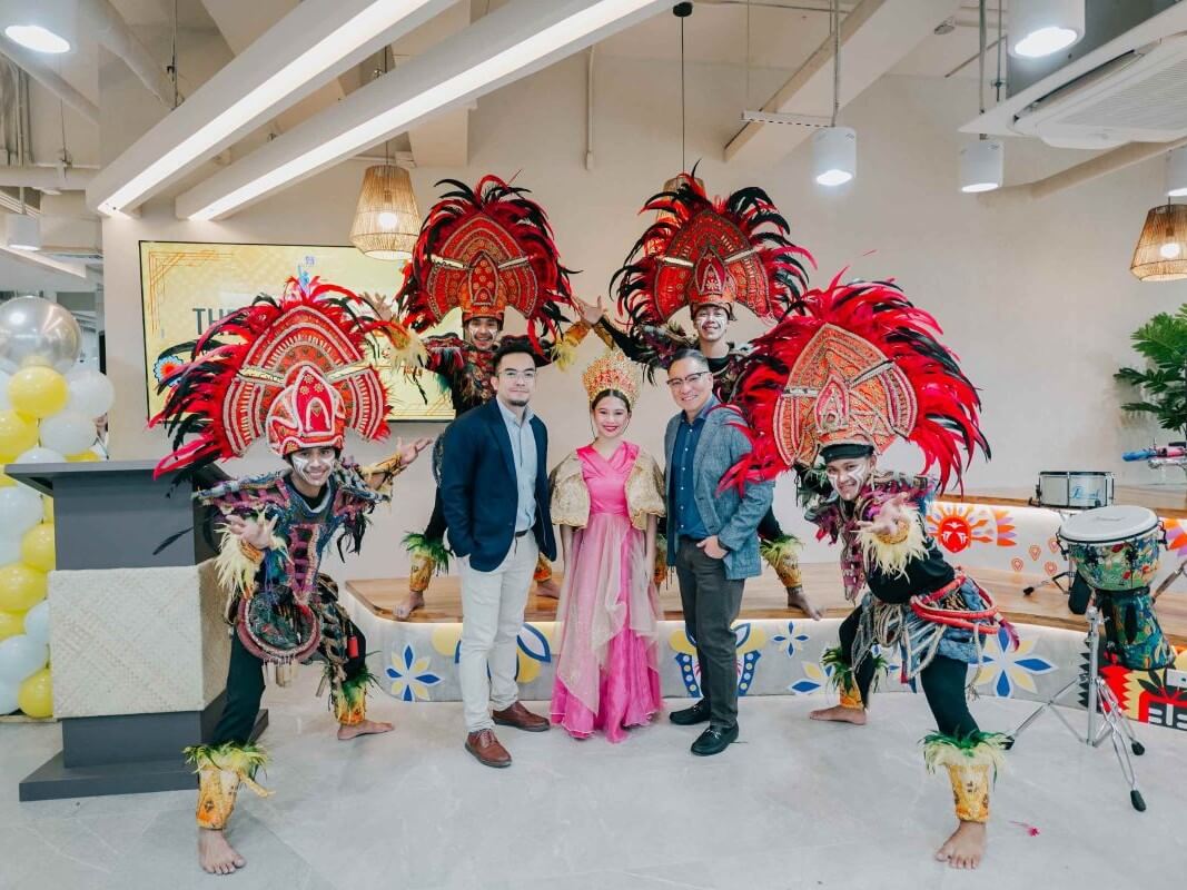 Elton John N. Peralta, senior director and head of work.able, and Jericho P. Go, SVP and business unit GM and work.able landlord, pose with the Dinagyang Dancers during the ceremonial opening of work.able Iloilo. | Contributed photo