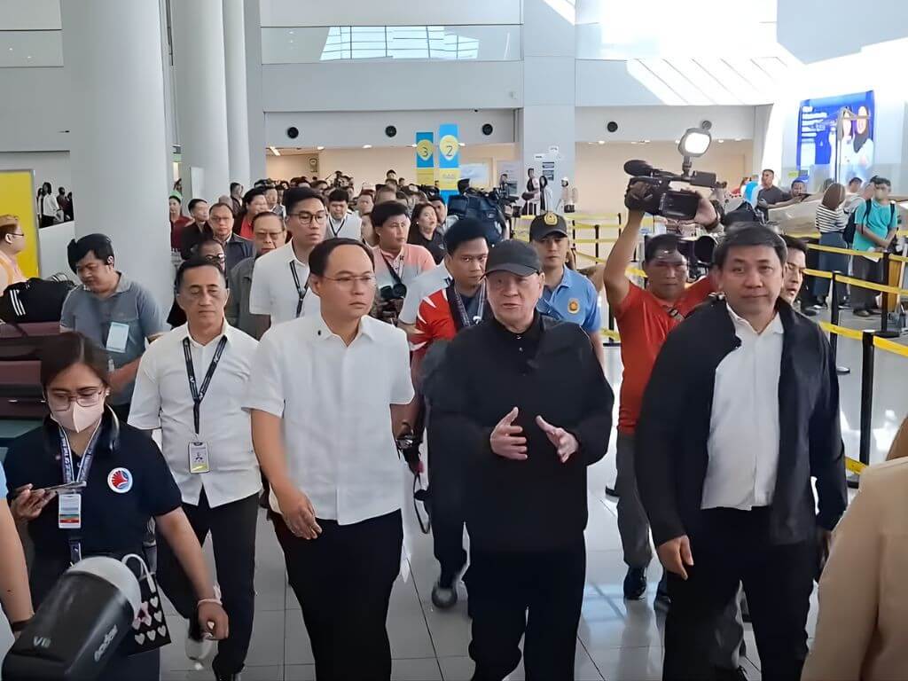 Transportation Sec. Giovanni Lopez, San Miguel Corp. chair and CEO Ramon Ang, and NNIC adviser Cesar Chiong lead the inspection of NAIA Terminal 3 on the morning of Thursday, Oct. 23, 2025./Screen capture from PTV4's Facebook feed.