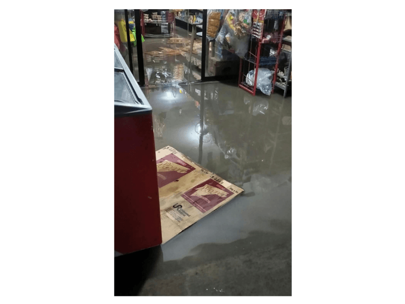 A sari-sari store continues to serve customers despite floodwaters entering its premises, providing residents with access to essential goods amid heavy monsoon rains. | Contributed photo