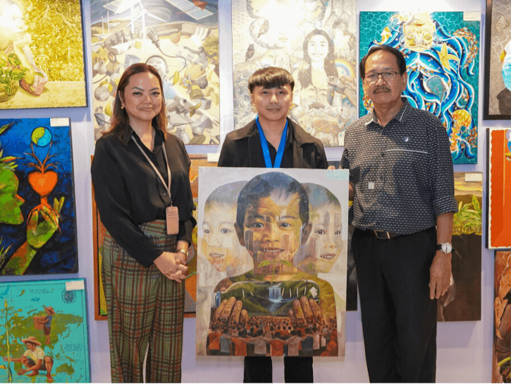Clark Manalo (center), who won first place for his artwork &ldquo;Holding Harmony&rdquo; at the inaugural Security Bank and Art Association of the Philippines (AAP) Paint for the Planet Art Competition, is pictured with Tanya Deakin, first vice president and corporate communications division head of Security Bank, and Fidel Sarmiento, president of AAP,during the awarding ceremony held at Security Bank Centre. | Contributed photo