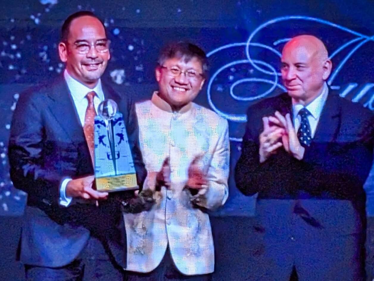 MGen president and CEO Emmanuel Rubio accepts MVP's Lifetime Contribution Award, with Asia CEO judges Roderick Danao and Don Felbaum. } Contributed photo