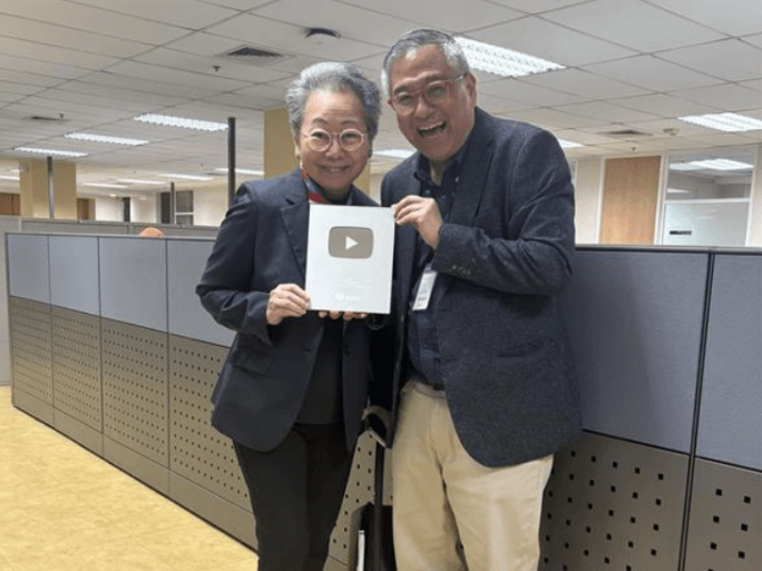 Rico Hizon, host and creator of SM In Focus, presents the YouTube Silver Play Button marking the platform&rsquo;s 100,000-subscriber milestone alongside SM Investments executive vice president, Group Diversity officer, and SM In Focus executive producer Lizanne Uychaco. | Contributed photo