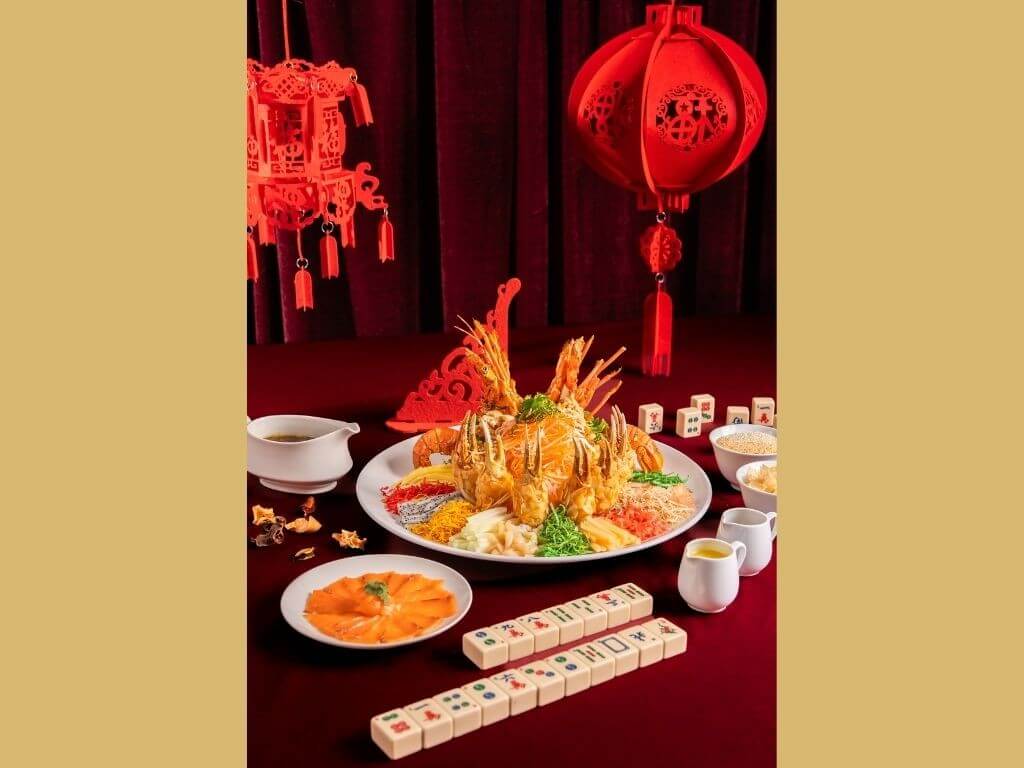 Guests can partake in Conrad Manila&rsquo;s Prosperity Yee Sang experience&mdash;a vibrant raw fish salad crowned with fresh salmon, succulent crab claw, and a medley of colorful vegetables. | Contributed photo