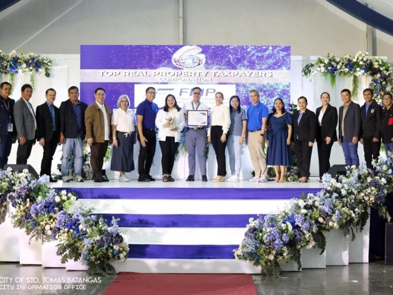 Santo Tomas City Mayor Arth Jhun “Ajam” Marasigan (seventh from left) and Vice Mayor Catherine “Cathy” Jaurigue-Perez (10 th from left) present to FPIP senior manager John Carlo Navalta (ninth from left) a plaque recognizing the ecozone as one of the city’s top taxpayers. Joining them are other officials and employees of both the Santo Tomas City LGU and FPIP. | ​Contributed photo