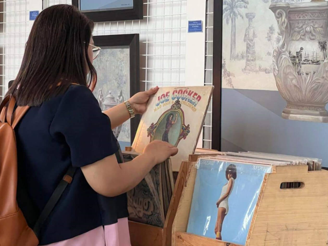  A guest perusing vinyl records during the Vinyl, Vino, Vici, event/ contributed photo