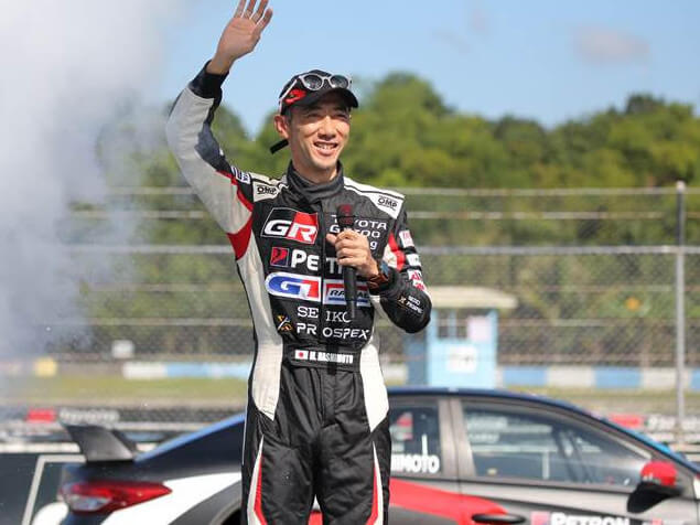 TMP president and Novice Class racer Masando Hashimoto waves to crowd during opening program