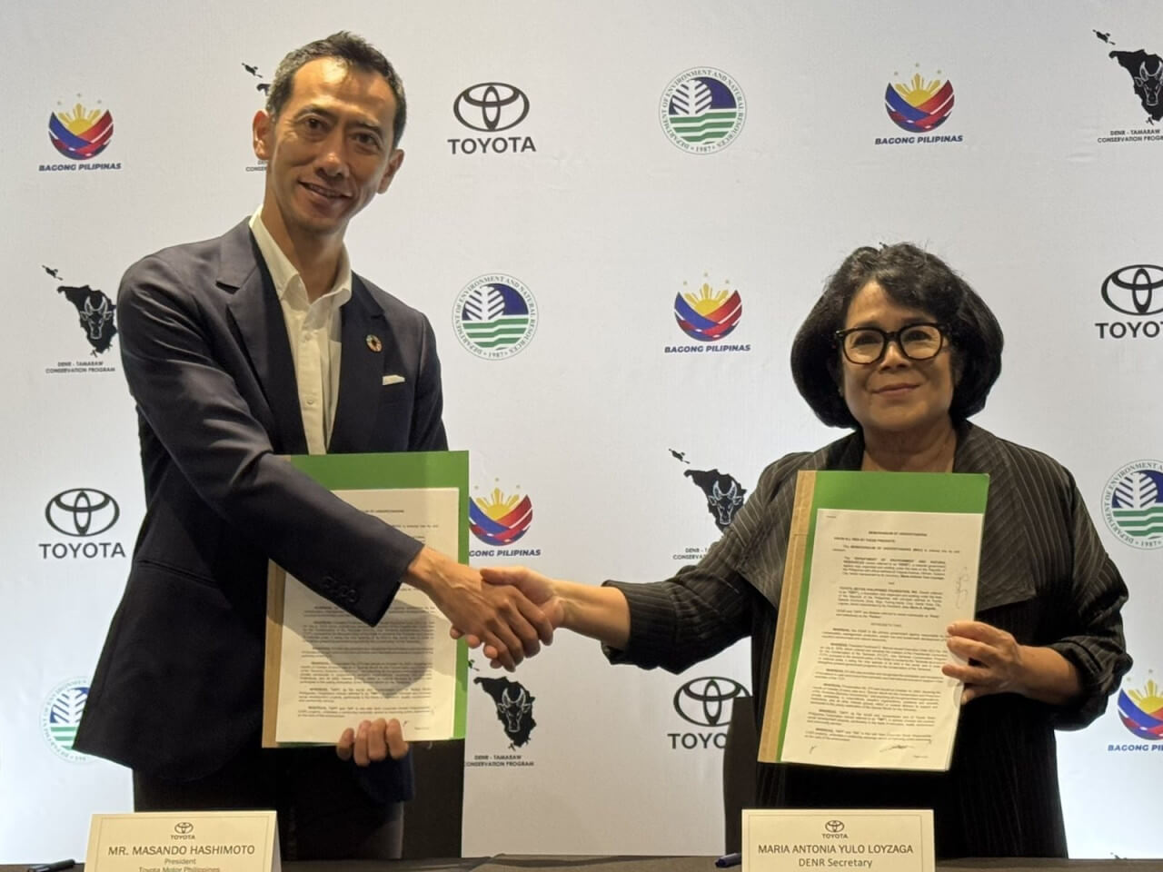 TMP president Masando Hashimoto (left) and Environment Secretary Maria Antonia Yulo Loyzaga with the signed Memorandum of Understanding that will reinforce the implementation of the Tamaraw Conservation Program./Contributed photo