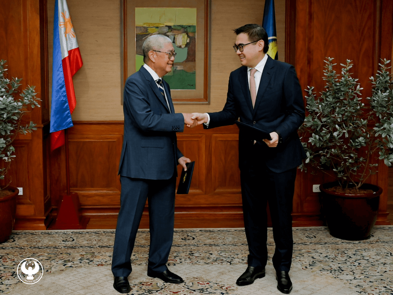BSP Governor and Monetary Board Chair Eli Remolona Jr. (left) congratulates Finance Secretary Frederick Go after he was sworn in to the seven-man policy making body of the central bank on Thursday, Jan. 8, 2026./Contributed photo